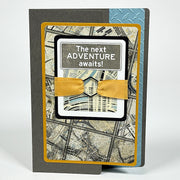 Greeting card with map design and 'The next ADVENTURE awaits!' text on a white background