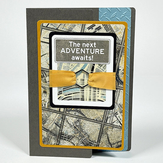 Greeting card with map design and 'The next ADVENTURE awaits!' text on a white background