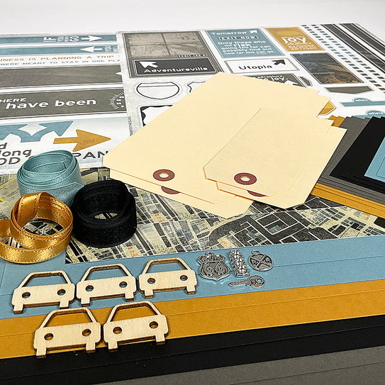 Collection of paper cutouts, envelopes, and small decorative items on a textured surface.